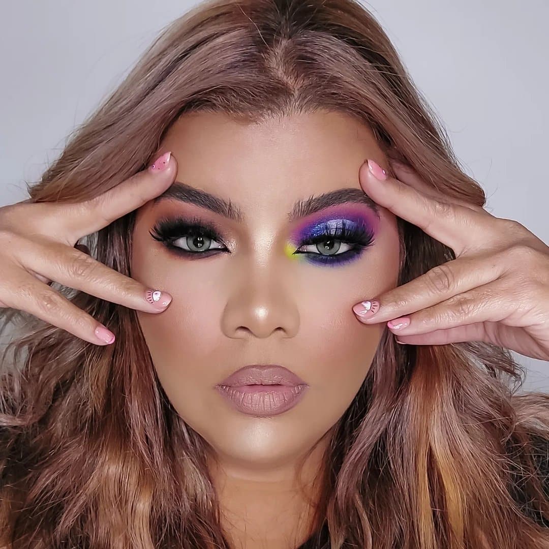 A woman with colorful makeup on her face.