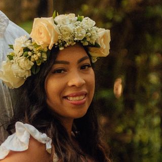 A man and a woman wearing a flower crown.