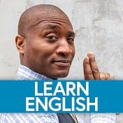 A man in a blue shirt with the words learn english.