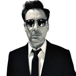 A black and white photo of a man in a suit and sunglasses.