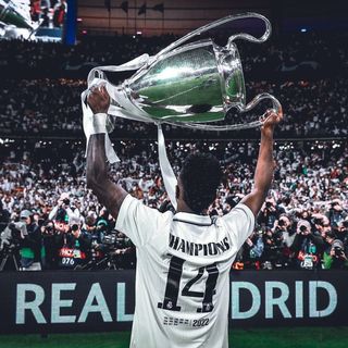 A man holding up a trophy in front of a crowd.