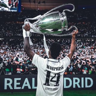 A man holding up a trophy in front of a crowd.