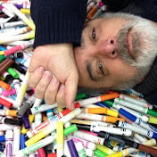 A man laying in a pile of markers as one of the most famous teacher youtube channels.