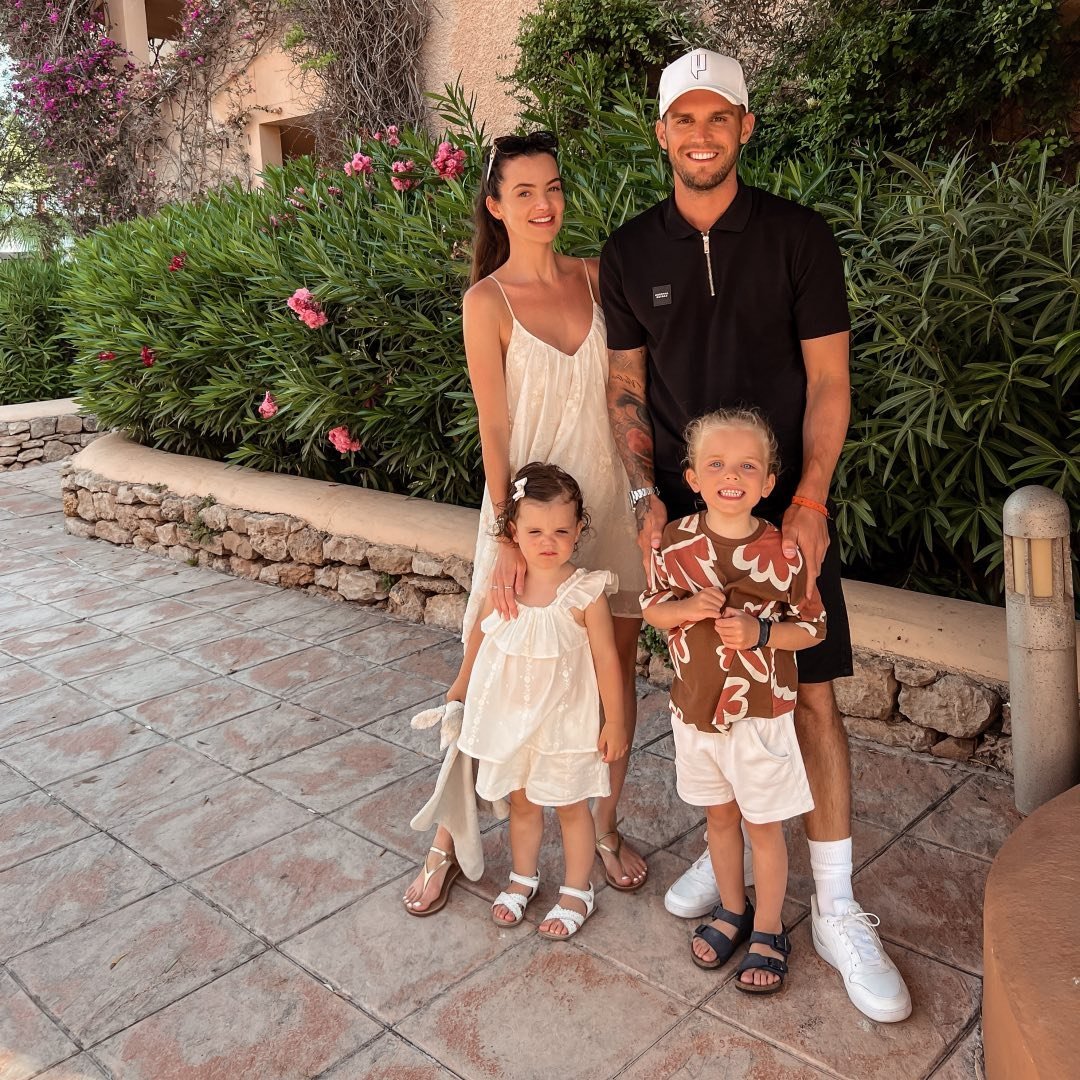 A man and woman pose for a picture with their children.