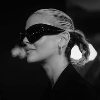 A black and white photo of a woman wearing sunglasses.