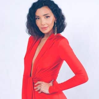 A woman in a red dress posing for a photo.