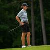 A golfer standing on a golf course.