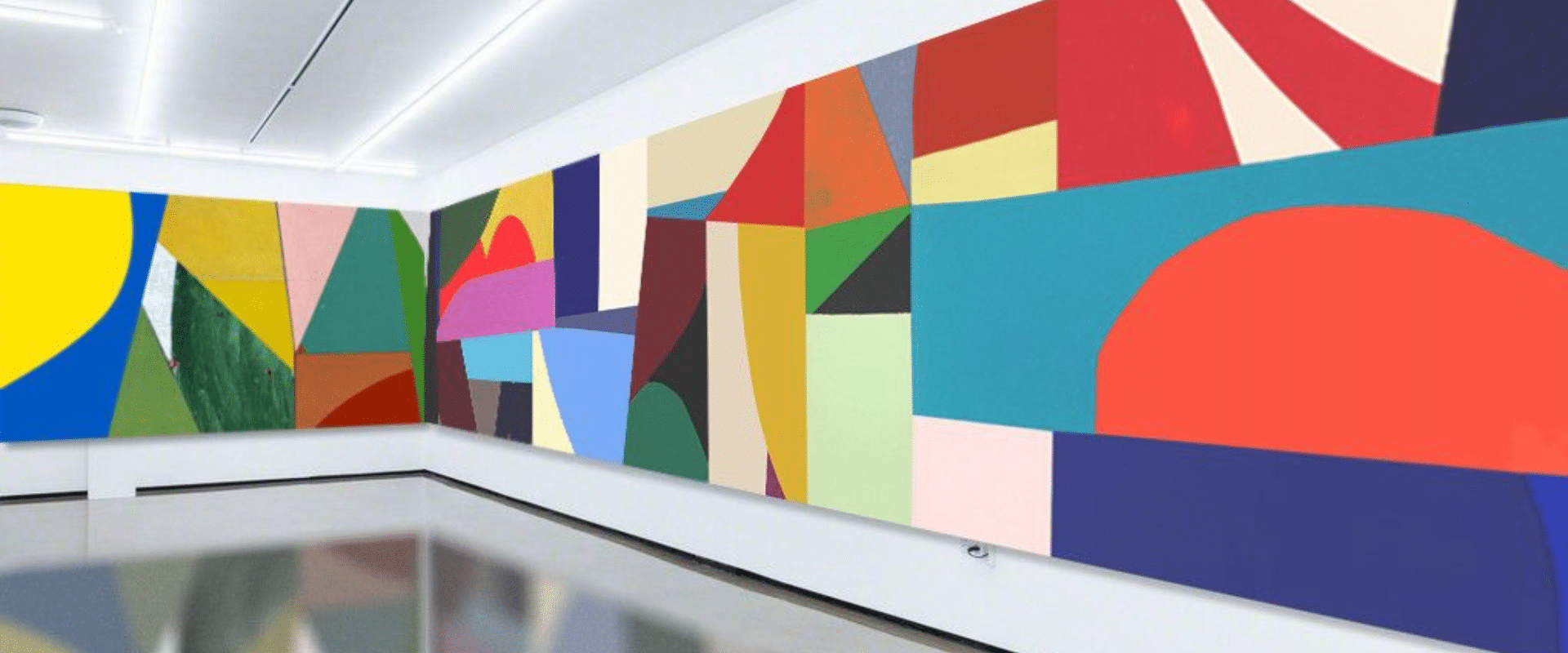 A room filled with colorful abstract paintings.