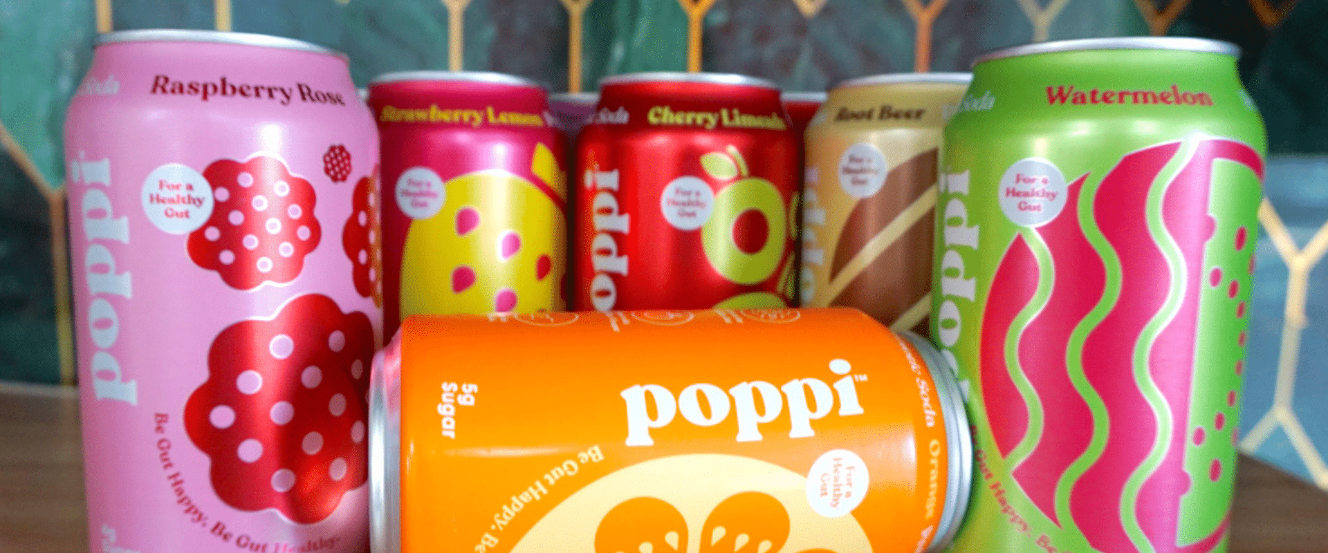 A group of cans of poppi are sitting on a table.