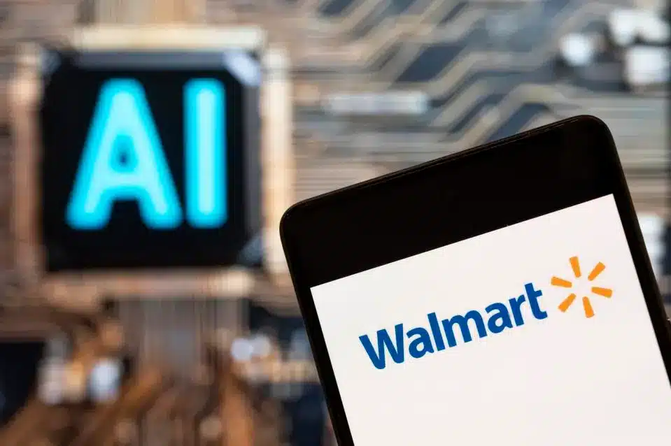 A smartphone displays the Walmart OpenAI logo in the foreground, with a blurred background showing the letters 
